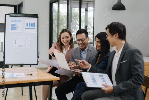 Collaboration and Analysis: A collaborative office scene with a diverse group of professionals, engaged in an analysis session, highlighting teamwork, communication, and data-driven decision-making.
