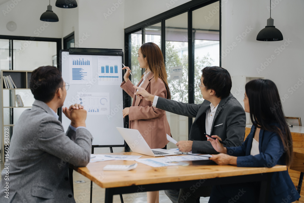 Business Collaboration: A team of professionals intently examines data on a flip chart during a business presentation, a collaborative effort. Business Collaboration: A team of professionals intently examines data on a flip chart during a business presentation, a collaborative effort.
