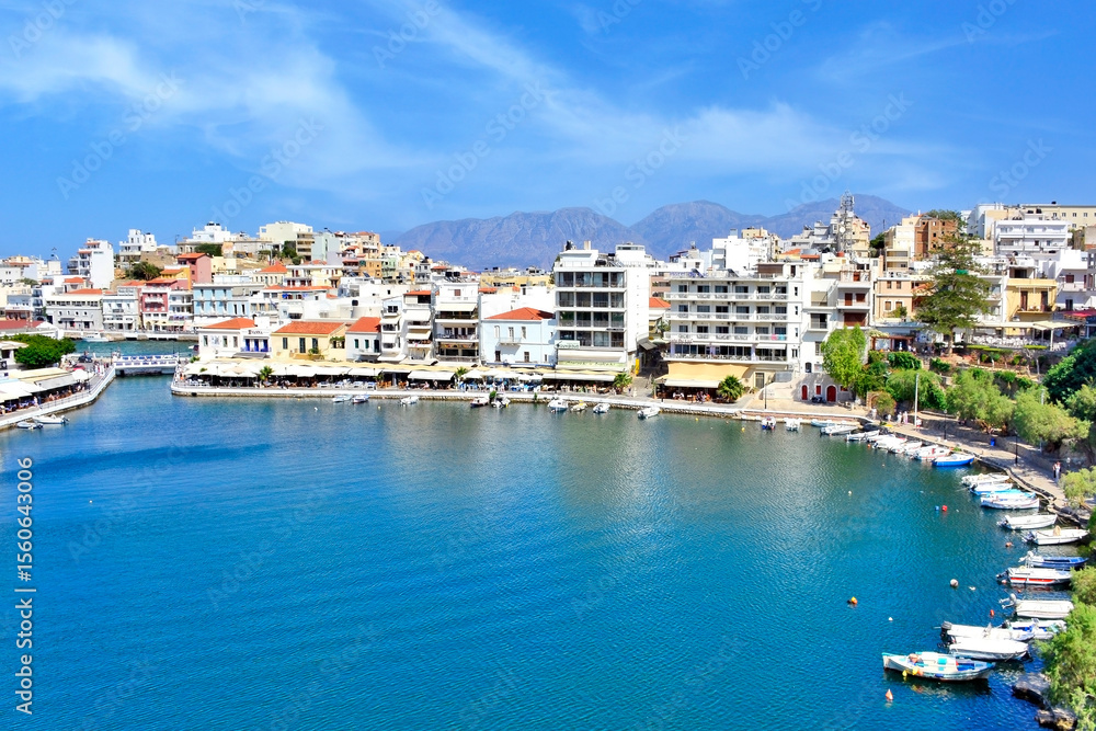 The lake Voulismeni in Agios Nikolaos, a picturesque coastal town with colorful buildings around the port in the eastern part of the island Crete, Greece The lake Voulismeni in Agios Nikolaos, a picturesque coastal town with colorful buildings around the port in the eastern part of the island Crete, Greece