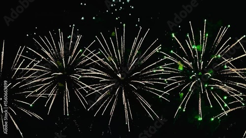  4K. loop seamless of real fireworks background golden shining fireworks with bokeh lights in the night sky. glowing fireworks show. New year's eve fireworks celebration multiple colors 