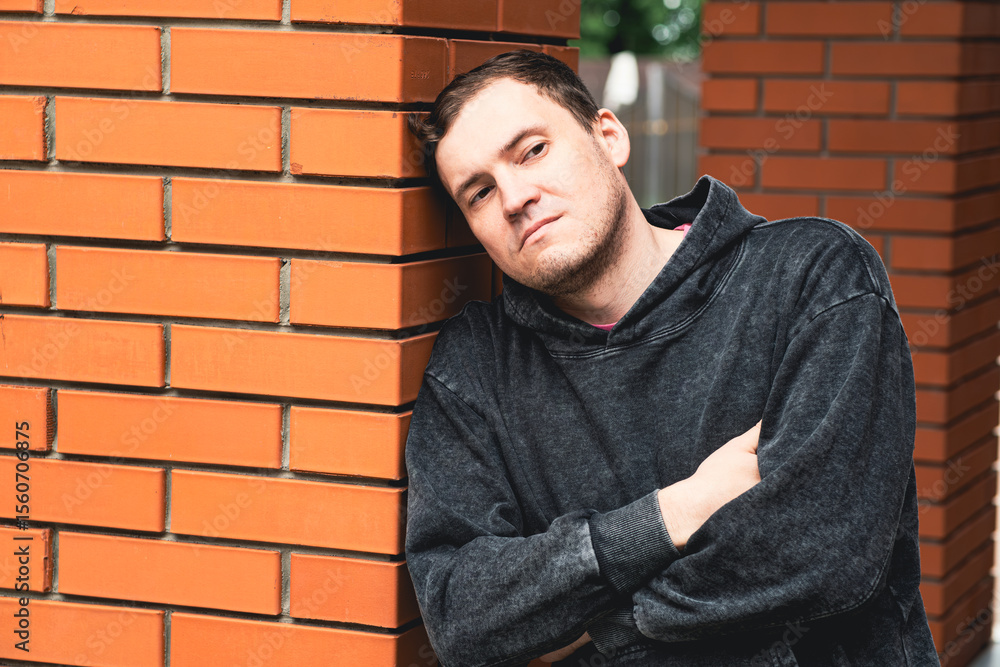 Man Leaning Against Brick Pillar in Urban Setting During Daytime Deep in Thought Man Leaning Against Brick Pillar in Urban Setting During Daytime Deep in Thought