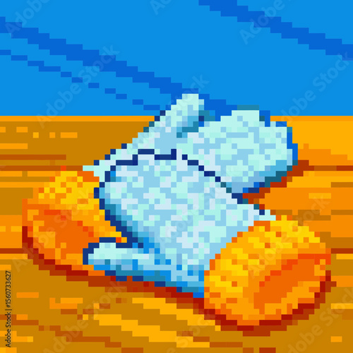 Pixel art illustration of baby booties in bright blue with orange trim on a wooden surface