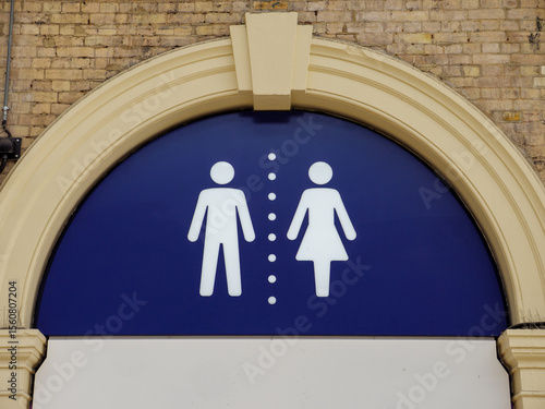 Men's and women's separate gender public toilet stickmen sign outside entrance