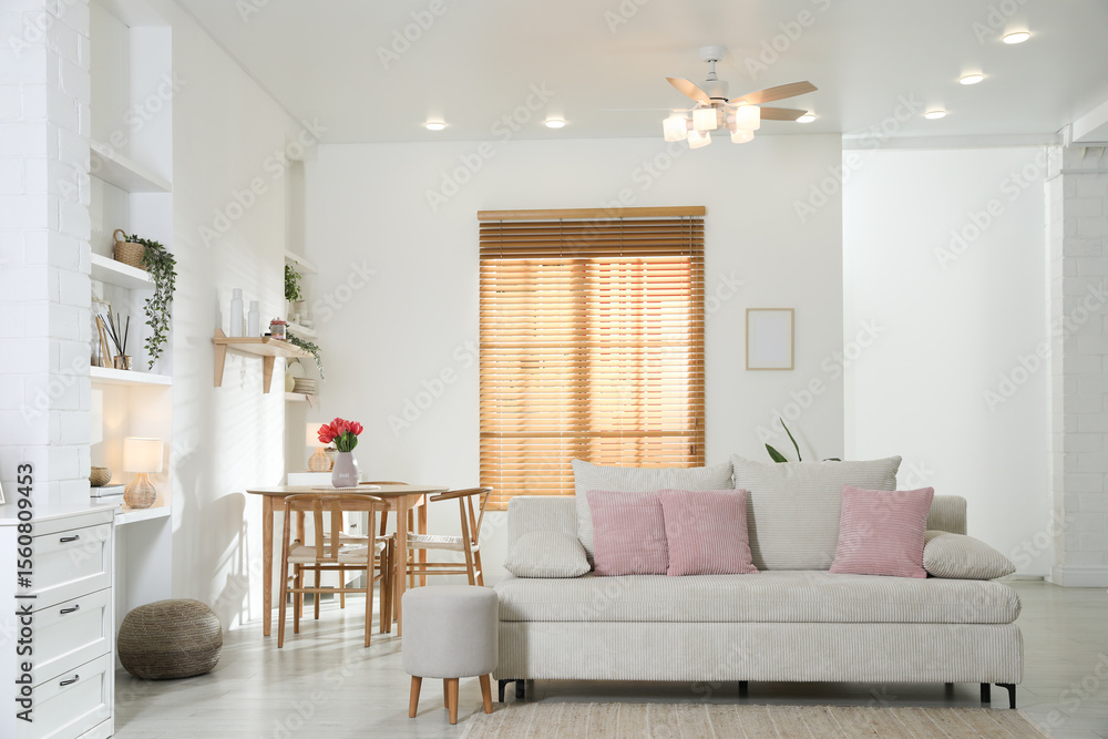 Stylish dining table with chairs and comfortable sofa in room. Interior design Stylish dining table with chairs and comfortable sofa in room. Interior design