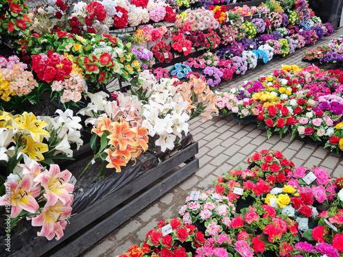 Vibrant array of artificial flowers in various colors and arrangements