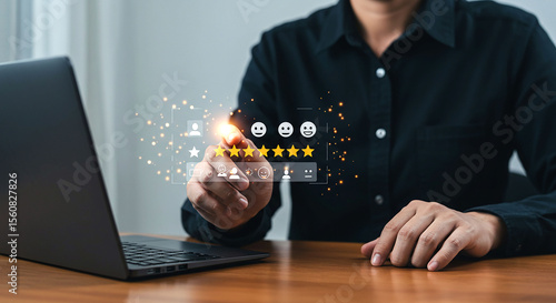 Person giving five star rating on transparent interface over laptop on wooden table surface view