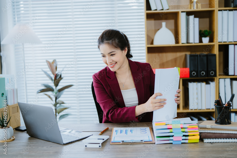 Asian businesswoman works with paper files, documents. Meeting to review work folders, recording info. Management concept. Laptop on desk. Financial reports, workplace research, information analysis, Asian businesswoman works with paper files, documents. Meeting to review work folders, recording info. Management concept. Laptop on desk. Financial reports, workplace research, information analysis,