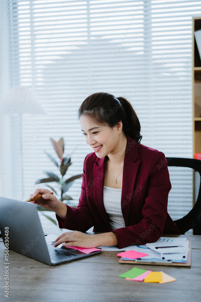 Focused asian businesswoman analyzing data on laptop in modern office, showcasing entrepreneurial spirit and professional expertise Focused asian businesswoman analyzing data on laptop in modern office, showcasing entrepreneurial spirit and professional expertise