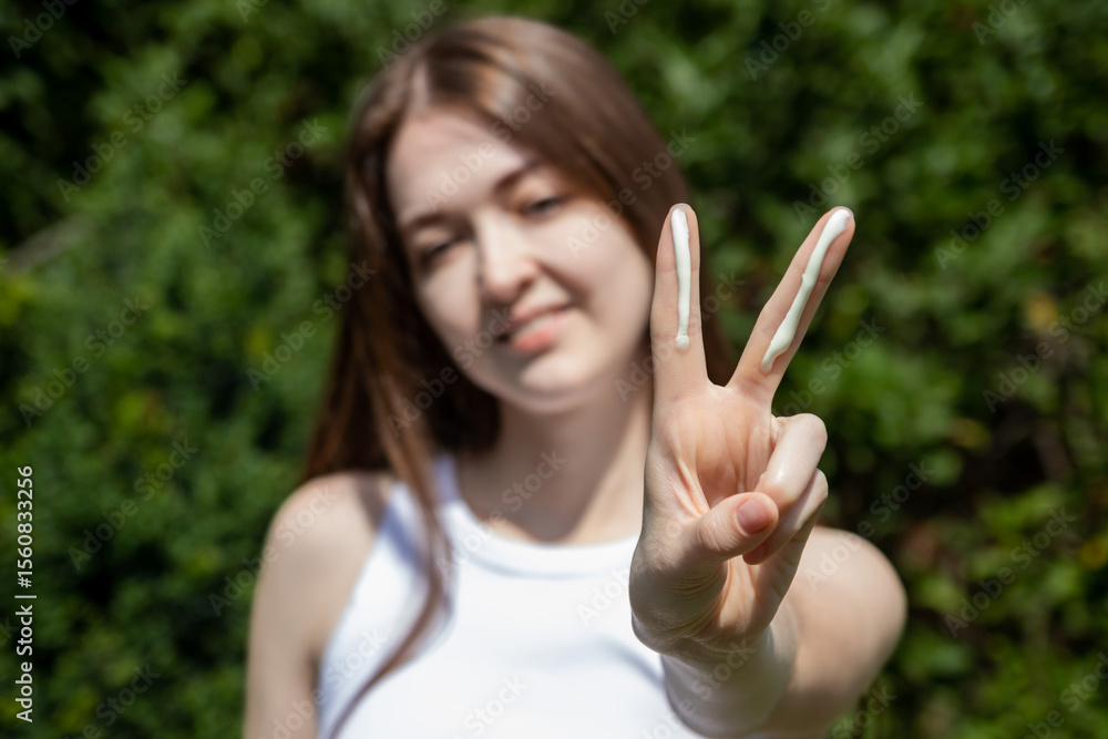 Young woman applying correct amount of sunscreen for face. Concept of sun protection, UV protection and summer skincare. Young woman applying correct amount of sunscreen for face. Concept of sun protection, UV protection and summer skincare.