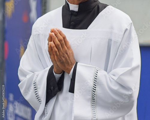 Details of the hands of a Catholic seminarian in prayer. Religious person.