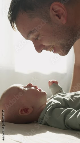 Three month old baby boy playing with father close up. Tender family morning in warm sunlights. Happy Parenthood. Unconditional Love of Dad and Child
