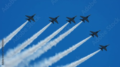 Formation of six fighter jets flying in the sky with white smoke trails during an air show display