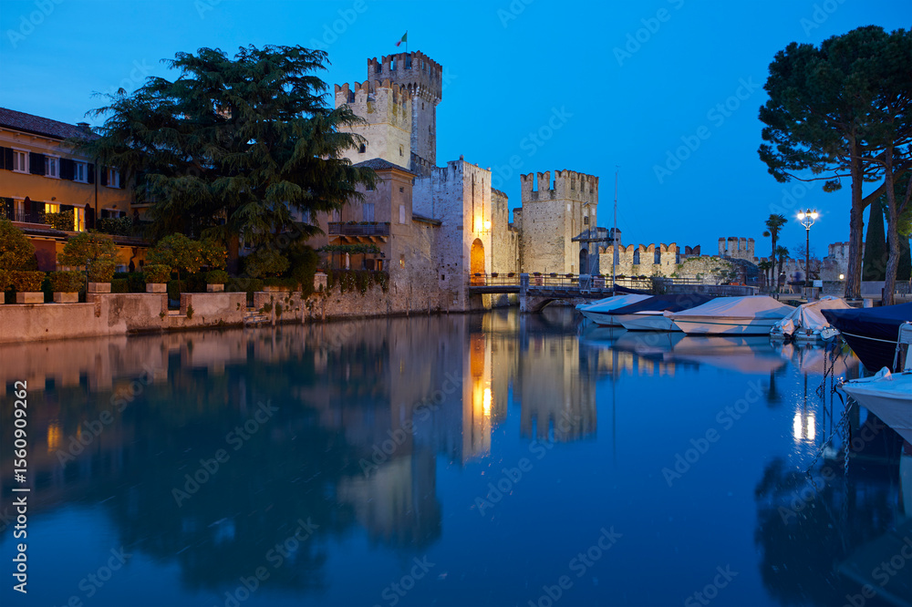 Fototapeta premium The scaliger castle of Sirmione, on the Garda lake, at blue hour, Sirmione, Italy