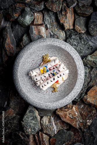 Delicate Mascarpone Vanilla Cream with Strawberry, Sumac, and Crispy Meringue on stones