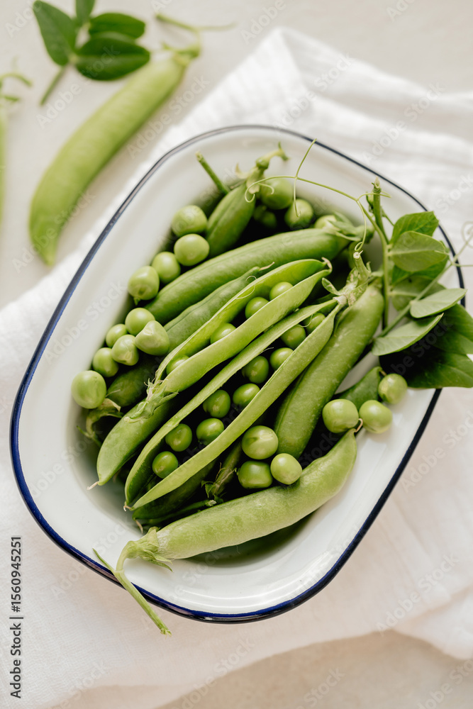 Fresh green peas in a white plate, healthy snack Fresh green peas in a white plate, healthy snack