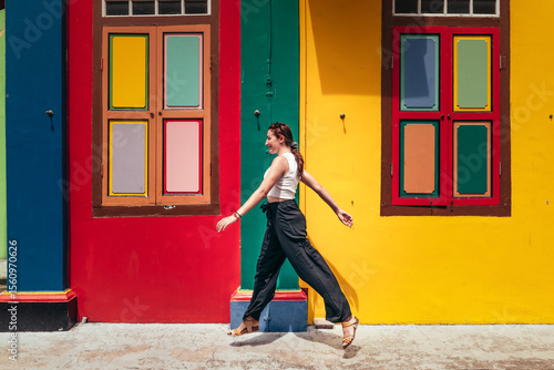 Photography Young woman walking in front of colorful houses in Little India, Singapore