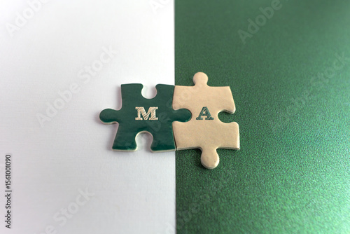A concept photo illustrating Merger and Acquisition (M&A), represented by interlocking green and white puzzle pieces placed on contrasting white and green backgrounds, symbolizing the union of two 