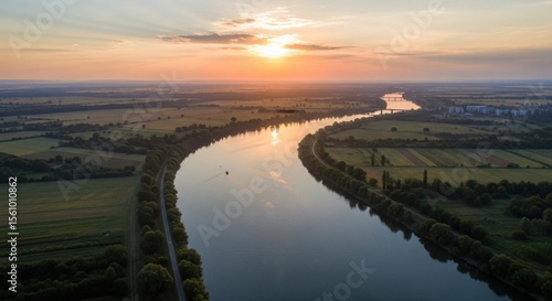 Wallpaper Mural Majestic River Bends Through Lush Green Countryside Under a Golden Sunset Sky Torontodigital.ca