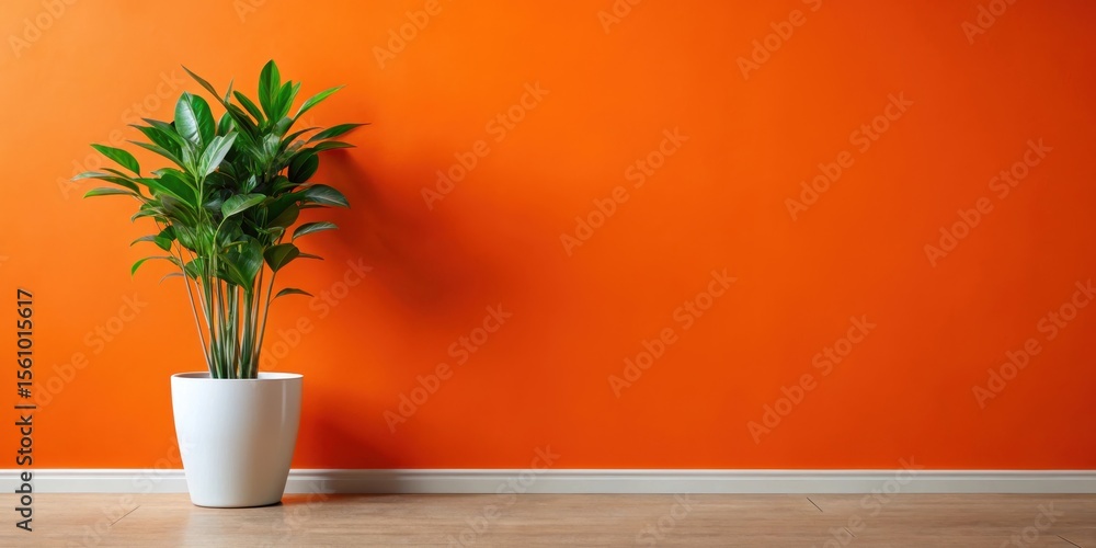 Fototapeta premium Vibrant Orange Wall with a Lush Green Plant in a Simple White Pot, Creating a Minimalist and Modern Interior Design Aesthetic