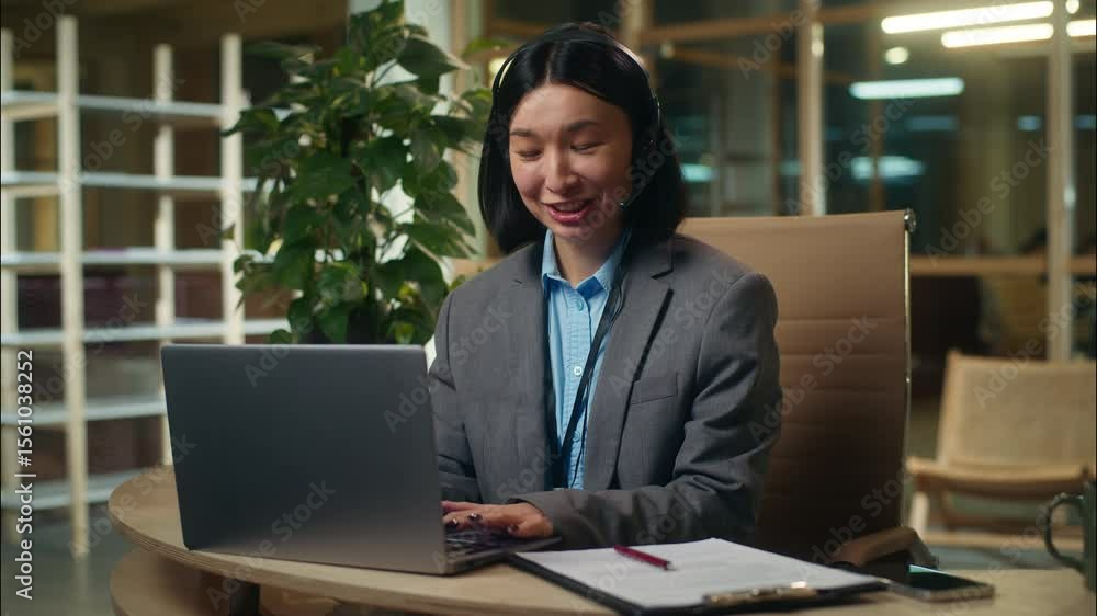 Cheerful friendly Asian Korean woman assistant consultant talking computer meeting business female businesswoman girl wear headset in office online conference client consumer help line worker service Cheerful friendly Asian Korean woman assistant consultant talking computer meeting business female businesswoman girl wear headset in office online conference client consumer help line worker service