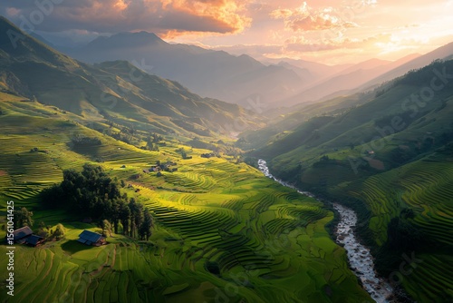 Expansive green rice terraces landscape winding through a deep valley under a dramatic cloudy sky with mountains in the background during the lush monsoon rainy season river