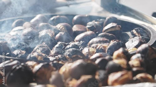 Cooking delicious roasted chestnuts in a bustling market