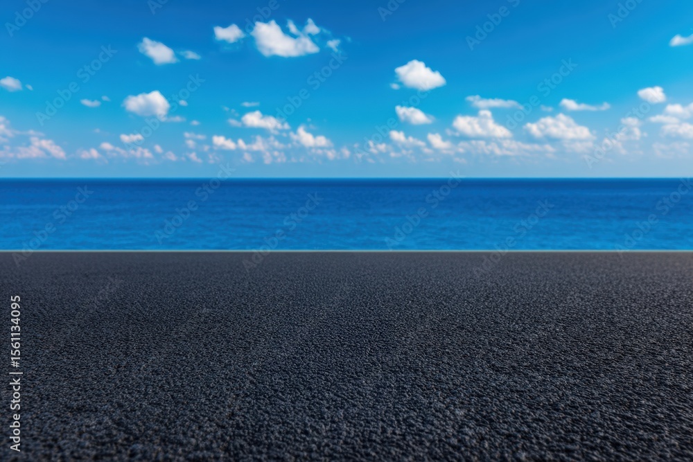Obraz premium Empty asphalt road leading to the ocean under a cloudy sky, offering a scenic view of freedom and travel