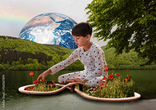 A boy in pajamas floats on a calm lake. Red poppies grow from the path, and colorful earth hangs majestically in the background, creating a strange and definite scene.