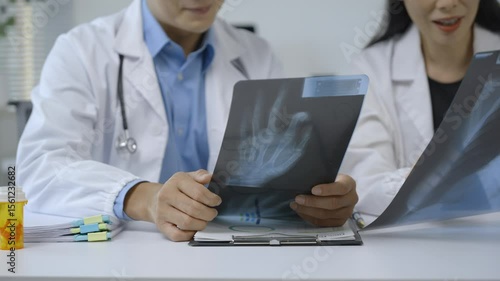 Wallpaper Mural Medical team collaborating around hand x ray, carefully reviewing bone structure and discussing potential diagnosis with professional expertise Torontodigital.ca