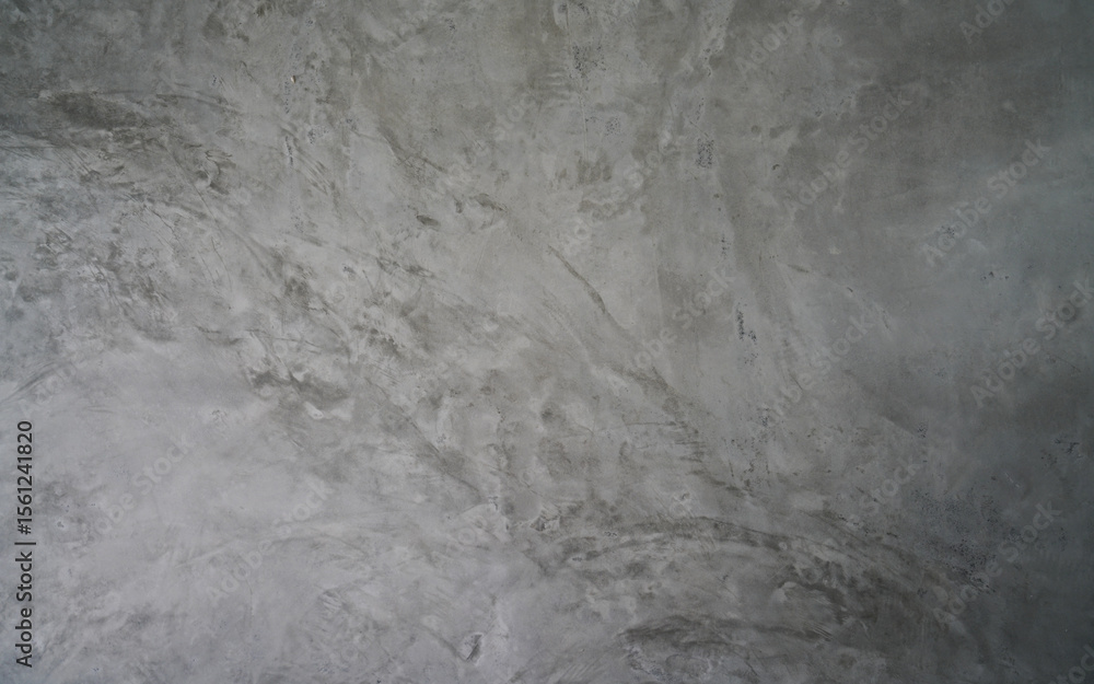 Fototapeta premium Grungy gray polished concrete wall with abstract patterns, perfect for a modern industrial or rustic background texture.