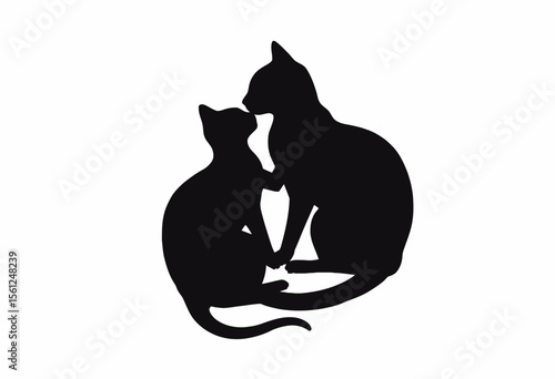 Two black cats sitting close together in playful interaction  