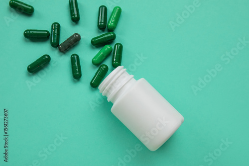 Jar with scattered pills on...