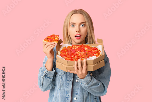 Young shocked woman holding...