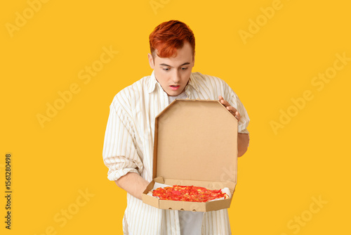 Shocked young man holding c...