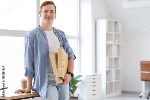Young businessman with fold...