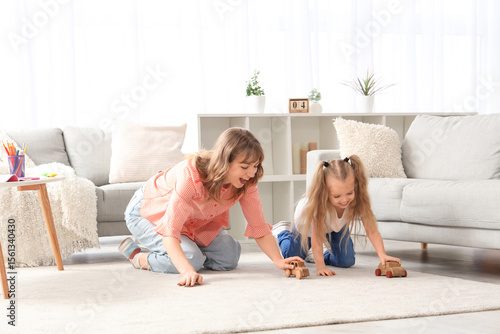 Nanny and little girl playi...