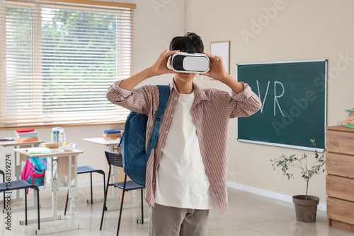 Teenage boy with VR glasses...