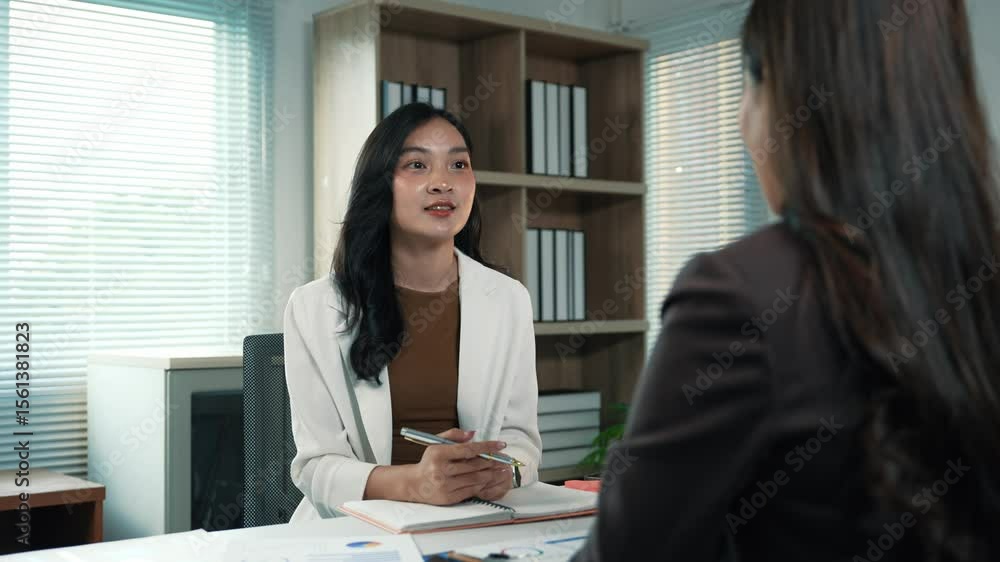 Businesswomen brainstorming and discussing business strategy during a meeting in modern office Businesswomen brainstorming and discussing business strategy during a meeting in modern office