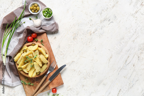 Wooden plate of tasty potat...