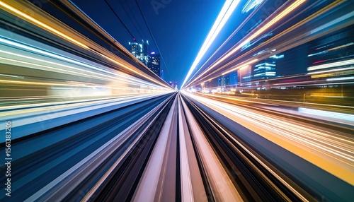 Train tracks perspective view with motion blurred light trails and city buildings visible in the background at night