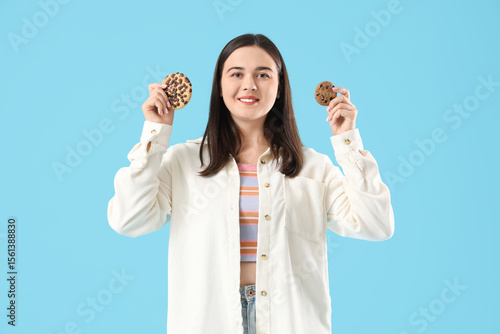 Young woman with cookies on...