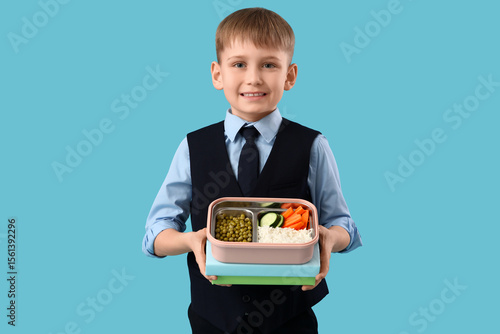 Cute little schoolboy holdi...