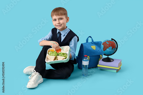 Cute little schoolboy with ...
