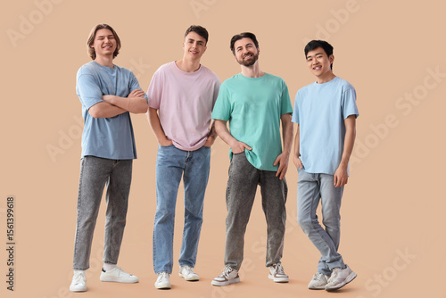 Group of young men on beige...