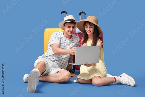 Couple of tourists with sui...
