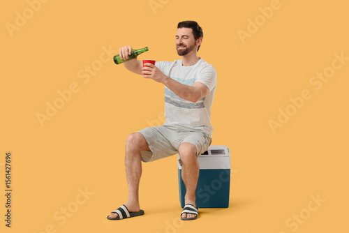 Happy young man sitting on ...