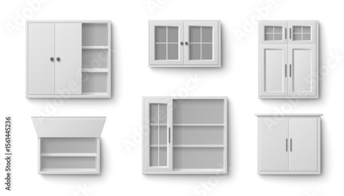 White kitchen cabinet collection in various storage styles. Different wall mounted units with glass doors, open shelving, closed panel fronts and upper furniture pieces for modern home organization.