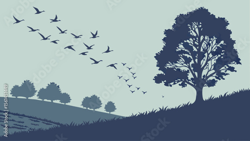 Silhouette image showing a flock of birds flying over trees and a grassy hill in a serene landscape