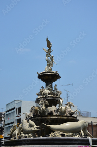 Payoon statue fountain or dugong monument roundabout on street at center old town city with traffic road intersection for thai people and travelers travel visit at Thap Thiang city in Trang, Thailand