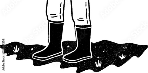 Farmer in rubber boots on soil surface - agriculture and rural life concept